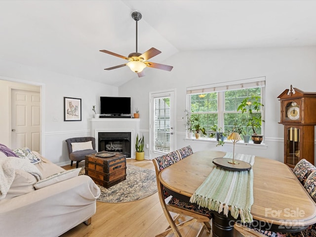 2214 Olde Chantilly Ct, Charlotte, NC 28205 - dining room with wood finished floors, lofted ceiling, a ceiling fan, and a fireplace