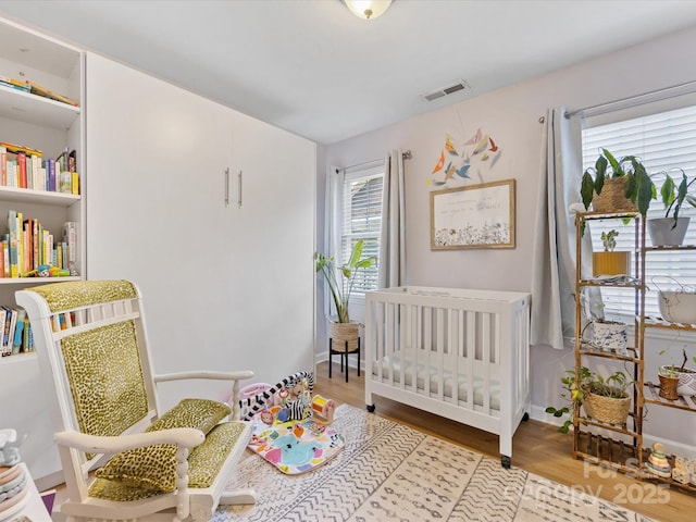 2214 Olde Chantilly Ct, Charlotte, NC 28205 - bedroom with wood finished floors and a nursery area