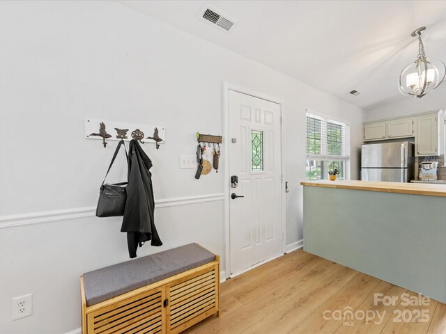 2214 Olde Chantilly Ct, Charlotte, NC 28205 - entryway featuring a chandelier, light wood-type flooring, vaulted ceiling, and baseboards