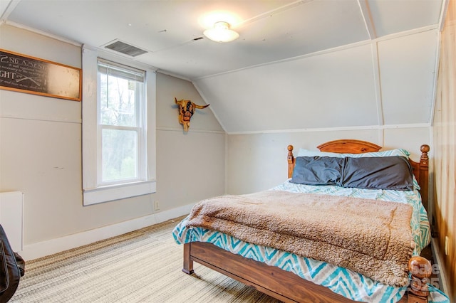 bedroom featuring visible vents, baseboards, and lofted ceiling