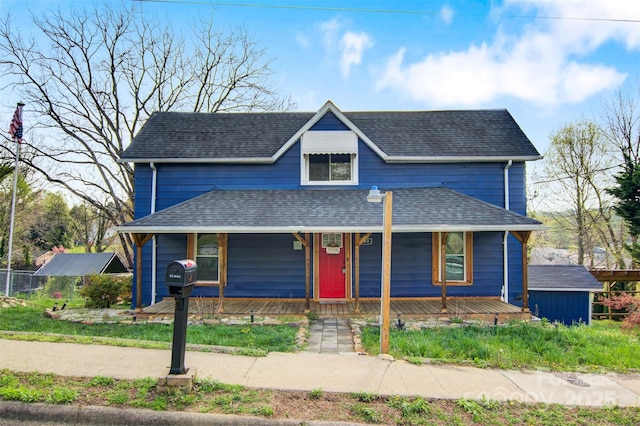 view of front of home with a porch and roof with shingles
