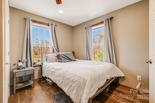 bedroom featuring baseboards and wood finished floors