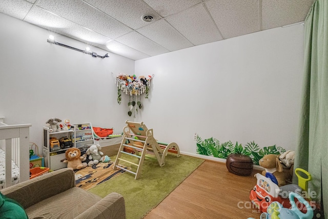 playroom featuring visible vents, wood finished floors, and a drop ceiling