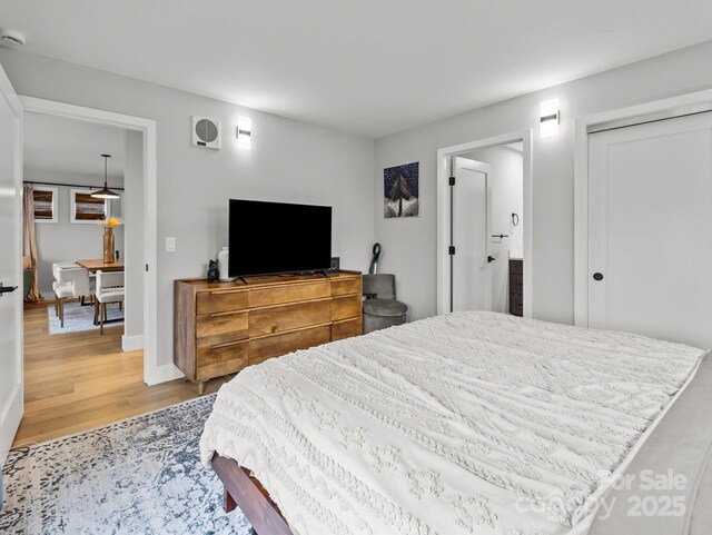 bedroom featuring baseboards and light wood finished floors