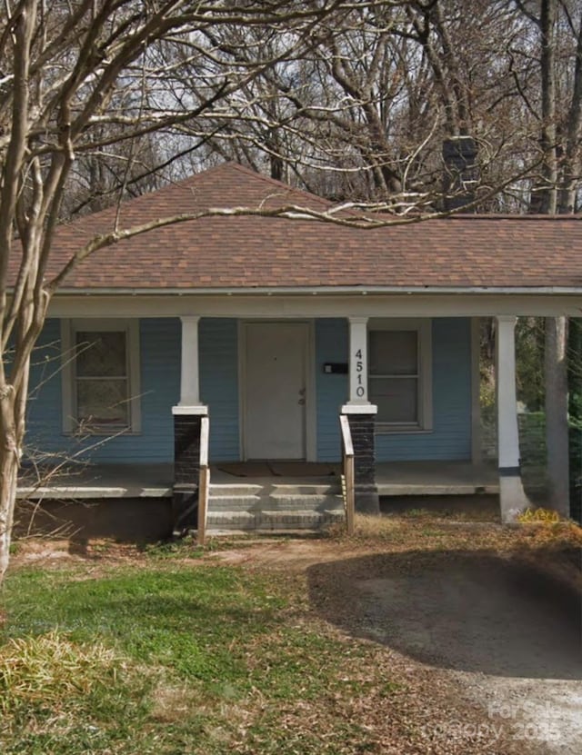 4510 Wildwood Ave, Charlotte, NC 28208 - view of front of home with a shingled roof and covered porch