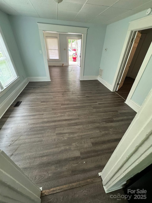 4510 Wildwood Ave, Charlotte, NC 28208 - hallway featuring baseboards, dark wood-style floors, visible vents, and a paneled ceiling