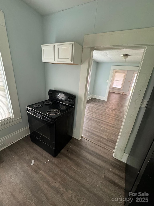 4510 Wildwood Ave, Charlotte, NC 28208 - kitchen with baseboards, white cabinetry, electric range, and dark wood-style flooring