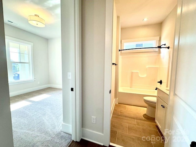 bathroom featuring shower / bath combination, baseboards, toilet, and visible vents