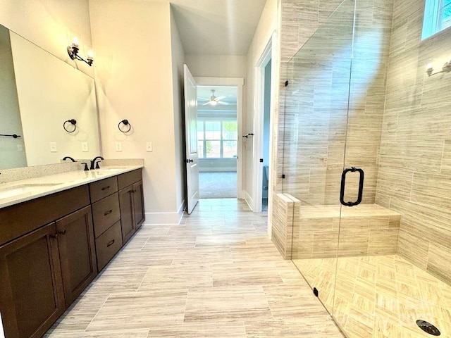 full bathroom with a sink, tile patterned flooring, a shower stall, and double vanity