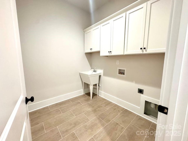 washroom with cabinet space, light tile patterned flooring, hookup for a washing machine, electric dryer hookup, and baseboards