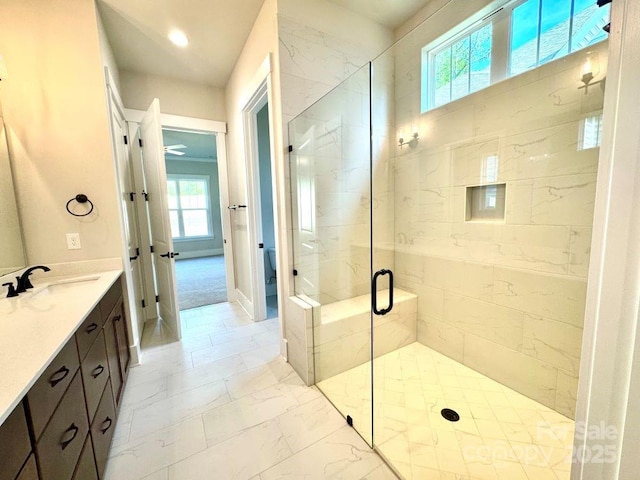 bathroom with vanity, marble finish floor, and a stall shower