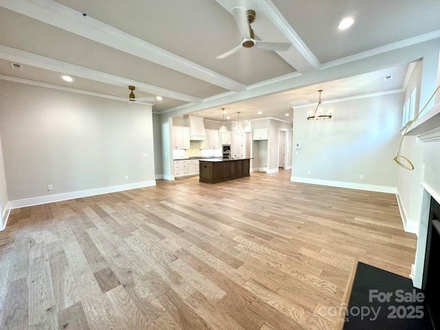 unfurnished living room featuring crown molding, beamed ceiling, baseboards, light wood-type flooring, and ceiling fan with notable chandelier