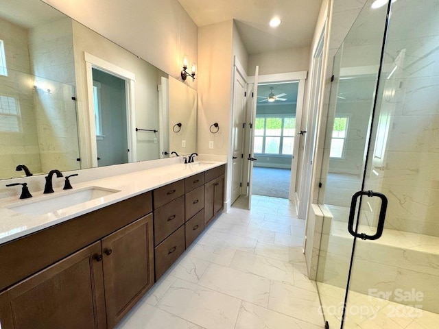 bathroom featuring a sink, marble finish floor, a ceiling fan, and a stall shower