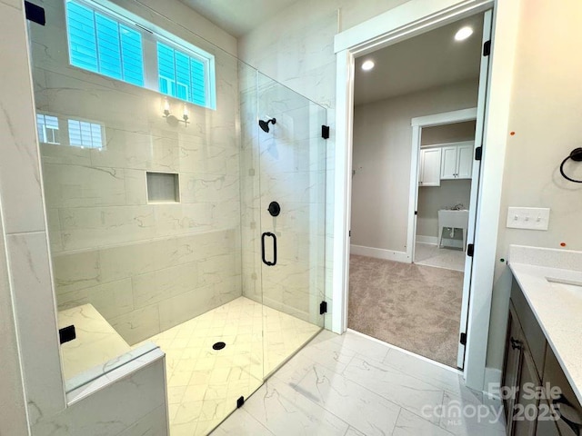 full bathroom with a stall shower, vanity, baseboards, marble finish floor, and recessed lighting