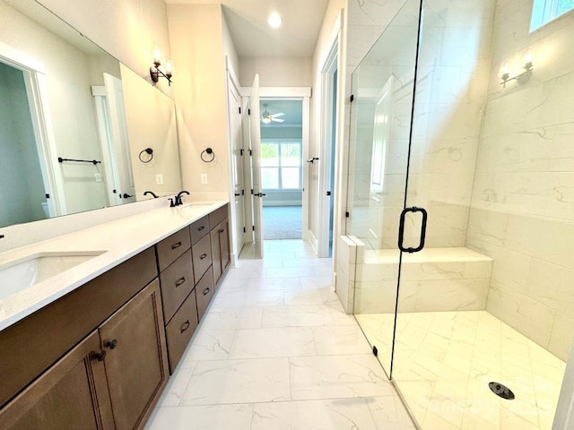 full bathroom with a sink, a shower stall, double vanity, and marble finish floor