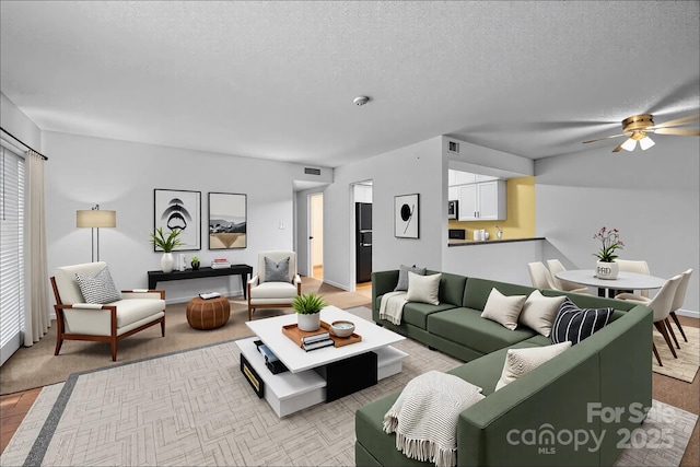 1832 J Julian Ln Unit D, Charlotte, NC 28208 - living room featuring a textured ceiling and ceiling fan