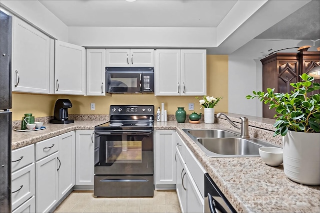 1832 J Julian Ln Unit D, Charlotte, NC 28208 - kitchen with black appliances, a sink, light countertops, and white cabinets