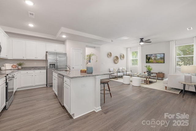 700 Sunset Pointe Dr, Salisbury, NC 28146 - kitchen featuring stainless steel appliances, a kitchen island with sink, wood finished floors, plenty of natural light, and recessed lighting