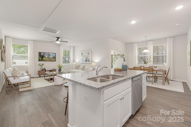 700 Sunset Pointe Dr, Salisbury, NC 28146 - kitchen with stainless steel dishwasher, white cabinetry, a kitchen island with sink, wood finished floors, and recessed lighting