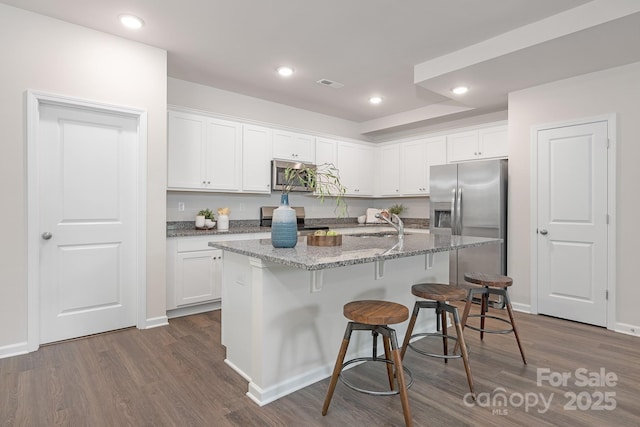 700 Sunset Pointe Dr, Salisbury, NC 28146 - kitchen with stainless steel appliances, white cabinetry, a kitchen bar, and recessed lighting
