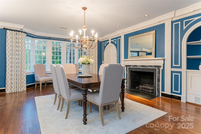 31 Busbee Rd, Asheville, NC 28803 - dining area featuring a chandelier, a premium fireplace, crown molding, and wood finished floors