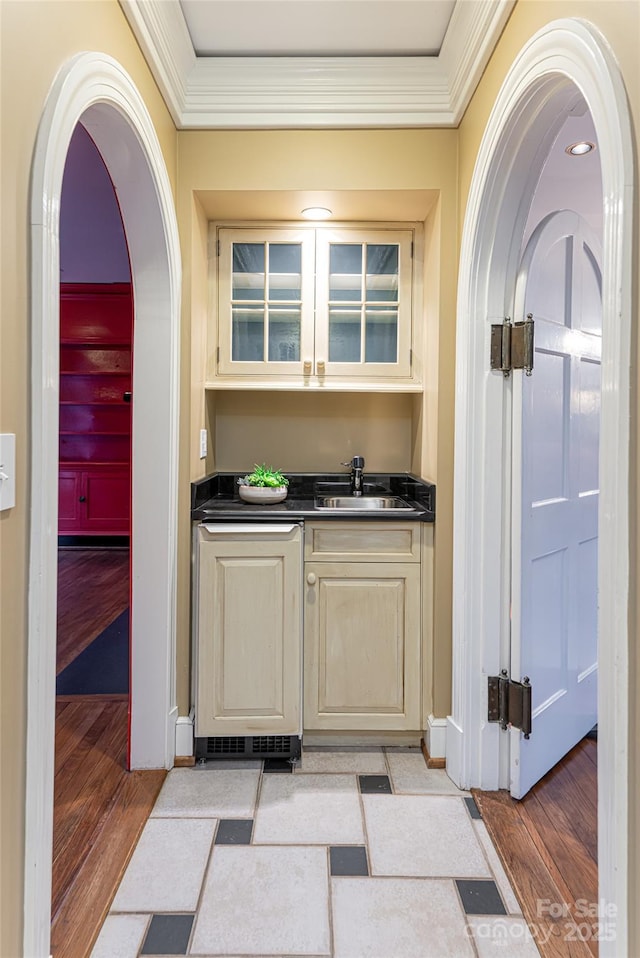 31 Busbee Rd, Asheville, NC 28803 - bar featuring a sink, ornamental molding, arched walkways, and light wood-style floors