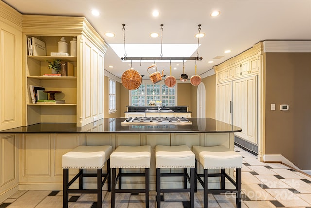 31 Busbee Rd, Asheville, NC 28803 - kitchen with a breakfast bar area, cream cabinetry, and dark countertops