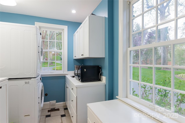 31 Busbee Rd, Asheville, NC 28803 - clothes washing area with light tile patterned floors, baseboards, stacked washer / dryer, laundry area, and recessed lighting