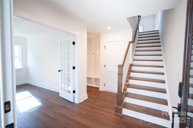 staircase with french doors, recessed lighting, baseboards, and wood finished floors