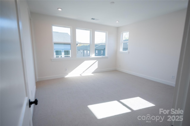 unfurnished room featuring carpet flooring, recessed lighting, baseboards, and visible vents