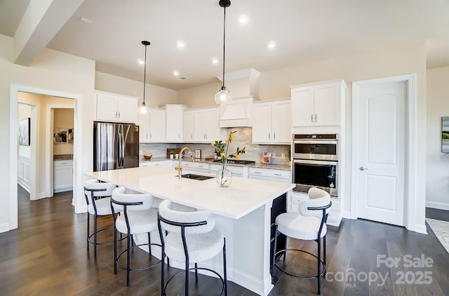 11144 Limehurst Pl, Charlotte, NC 28278 - kitchen with stainless steel appliances, backsplash, an island with sink, light countertops, and recessed lighting