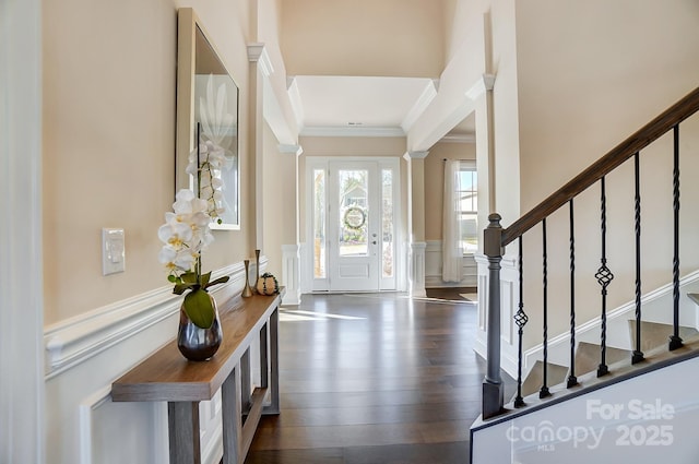 11144 Limehurst Pl, Charlotte, NC 28278 - foyer entrance with a decorative wall, ornamental molding, stairs, a wainscoted wall, and dark wood-style floors
