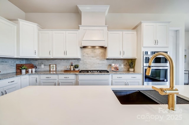 11144 Limehurst Pl, Charlotte, NC 28278 - kitchen with stainless steel appliances, white cabinets, and tasteful backsplash