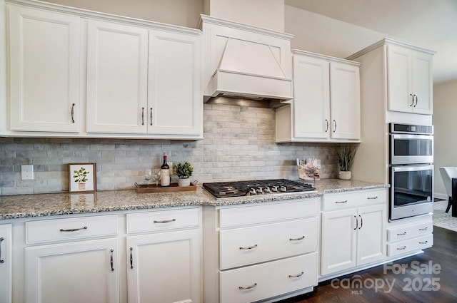 11144 Limehurst Pl, Charlotte, NC 28278 - kitchen with stainless steel appliances, white cabinetry, light stone counters, and decorative backsplash