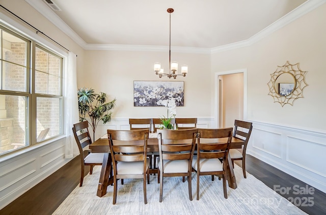 11144 Limehurst Pl, Charlotte, NC 28278 - dining space with wood finished floors, a chandelier, healthy amount of natural light, crown molding, and a decorative wall