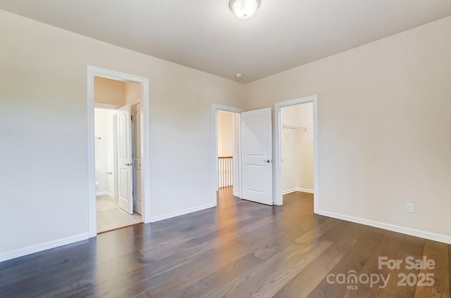 11144 Limehurst Pl, Charlotte, NC 28278 - unfurnished bedroom featuring wood finished floors, a spacious closet, a closet, and connected bathroom