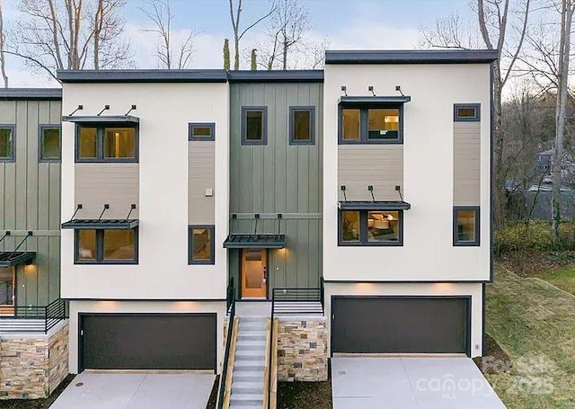 15 Macallan Ln Unit 21, Asheville, NC 28805 - view of front facade featuring a garage, board and batten siding, and concrete driveway