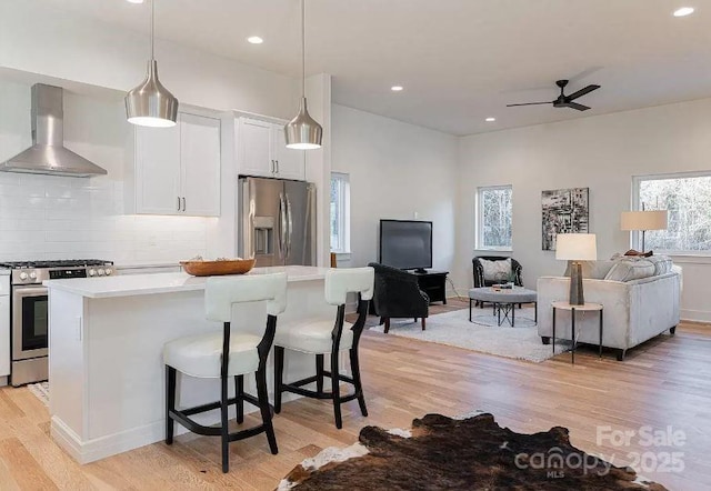 15 Macallan Ln Unit 21, Asheville, NC 28805 - kitchen featuring light countertops, light wood finished floors, wall chimney exhaust hood, appliances with stainless steel finishes, and open floor plan