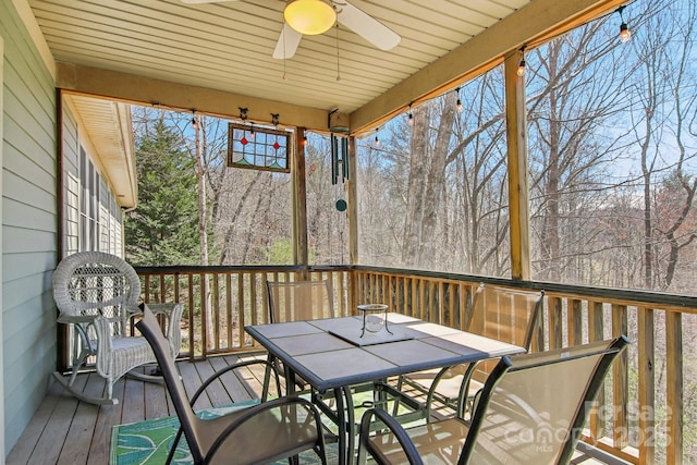 sunroom featuring a healthy amount of sunlight, ceiling fan, and outdoor dining space