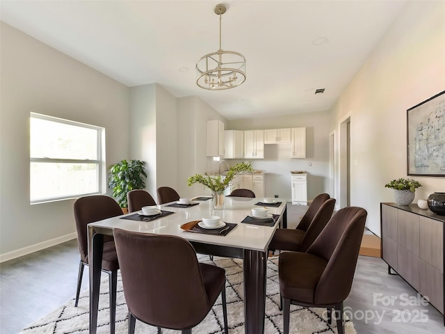 108 Graham St, Chester, SC 29706 - dining room featuring baseboards, a notable chandelier, visible vents, and light wood-type flooring