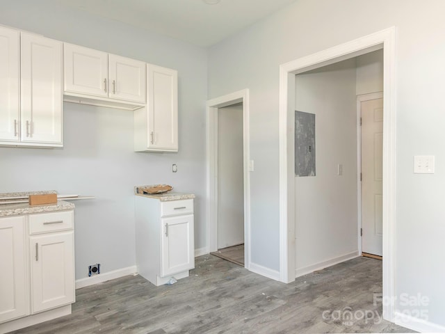 108 Graham St, Chester, SC 29706 - kitchen with white cabinetry, light wood-style floors, and baseboards