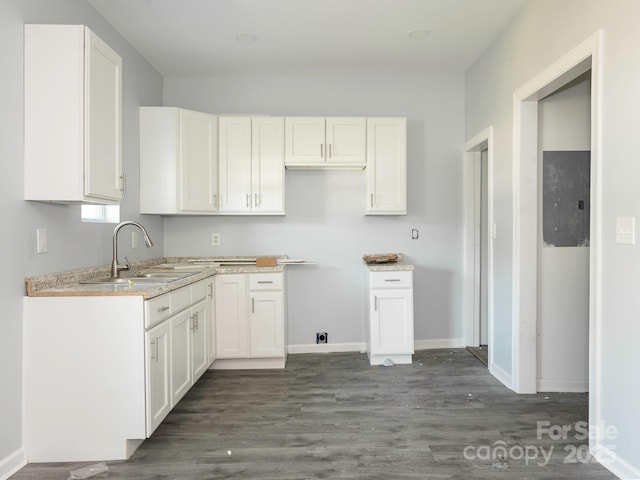 108 Graham St, Chester, SC 29706 - kitchen with a sink, dark wood finished floors, baseboards, and white cabinets