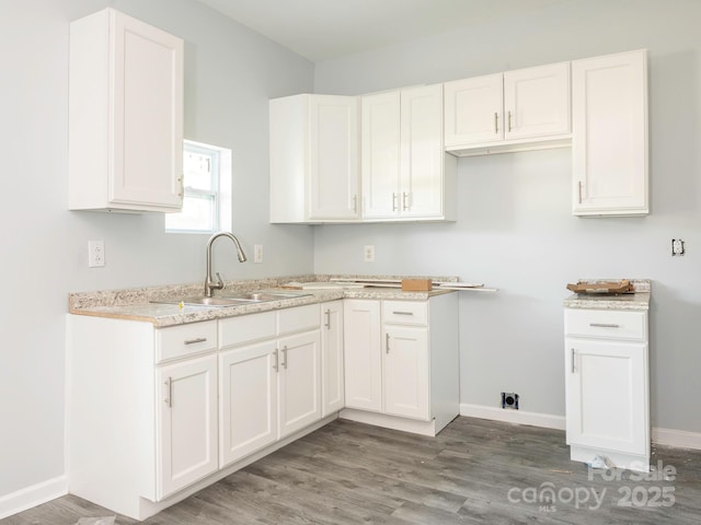 108 Graham St, Chester, SC 29706 - laundry room featuring baseboards, a sink, and wood finished floors
