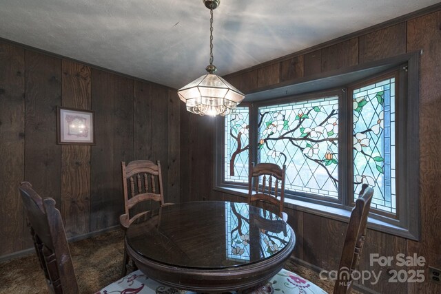 2610 Indian Grave Rd, Lenoir, NC 28645 - dining area featuring wooden walls, a chandelier, and baseboards