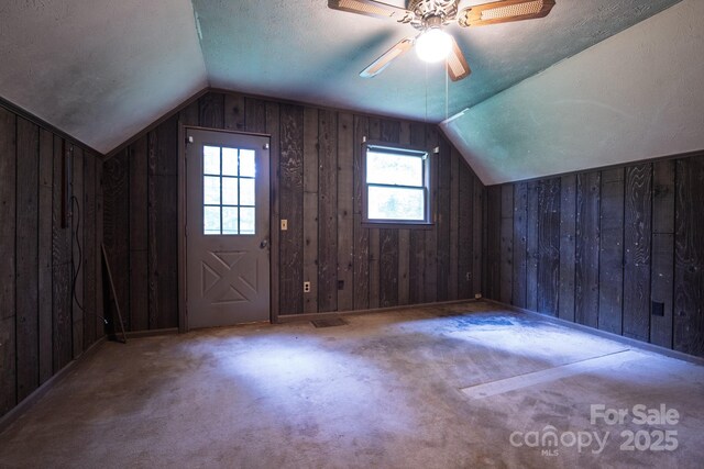 2610 Indian Grave Rd, Lenoir, NC 28645 - bonus room featuring lofted ceiling, wood walls, ceiling fan, carpet flooring, and a textured ceiling