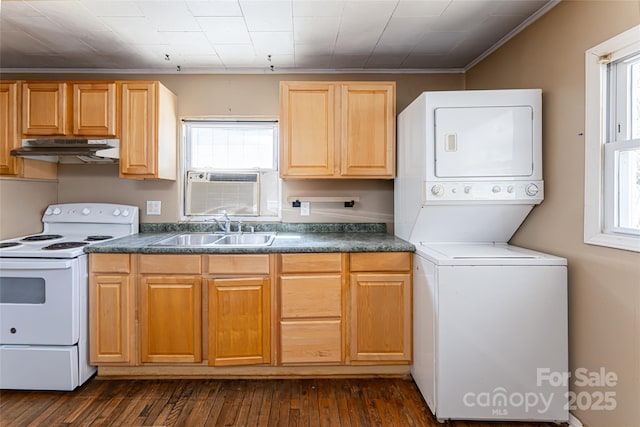 kitchen with stacked washer and dryer, a sink, white range with electric cooktop, under cabinet range hood, and dark countertops