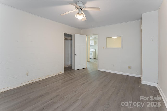 unfurnished bedroom featuring baseboards, a closet, ceiling fan, and wood finished floors