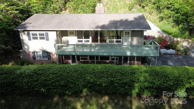 857 Country Club Dr, Maggie Valley, NC 28751 - rear view of house featuring brick siding and a chimney