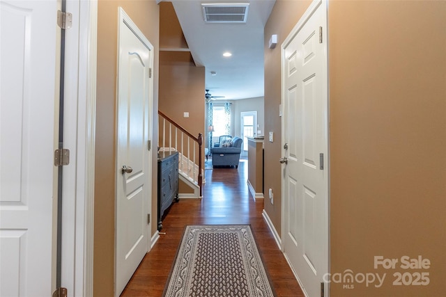 hall with visible vents, baseboards, recessed lighting, stairway, and dark wood finished floors