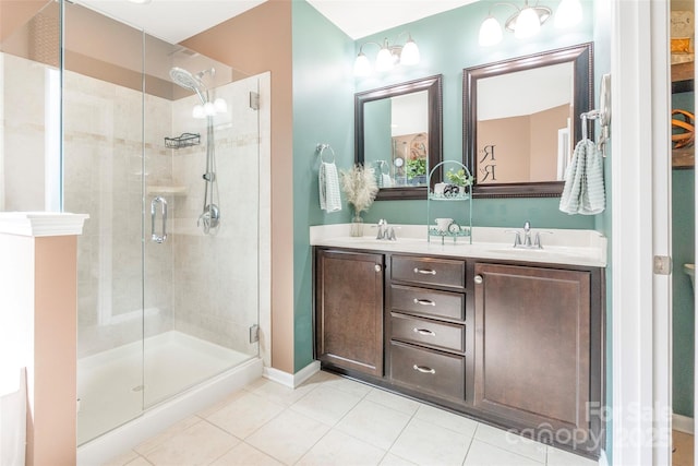 bathroom with a stall shower, tile patterned floors, double vanity, and a sink